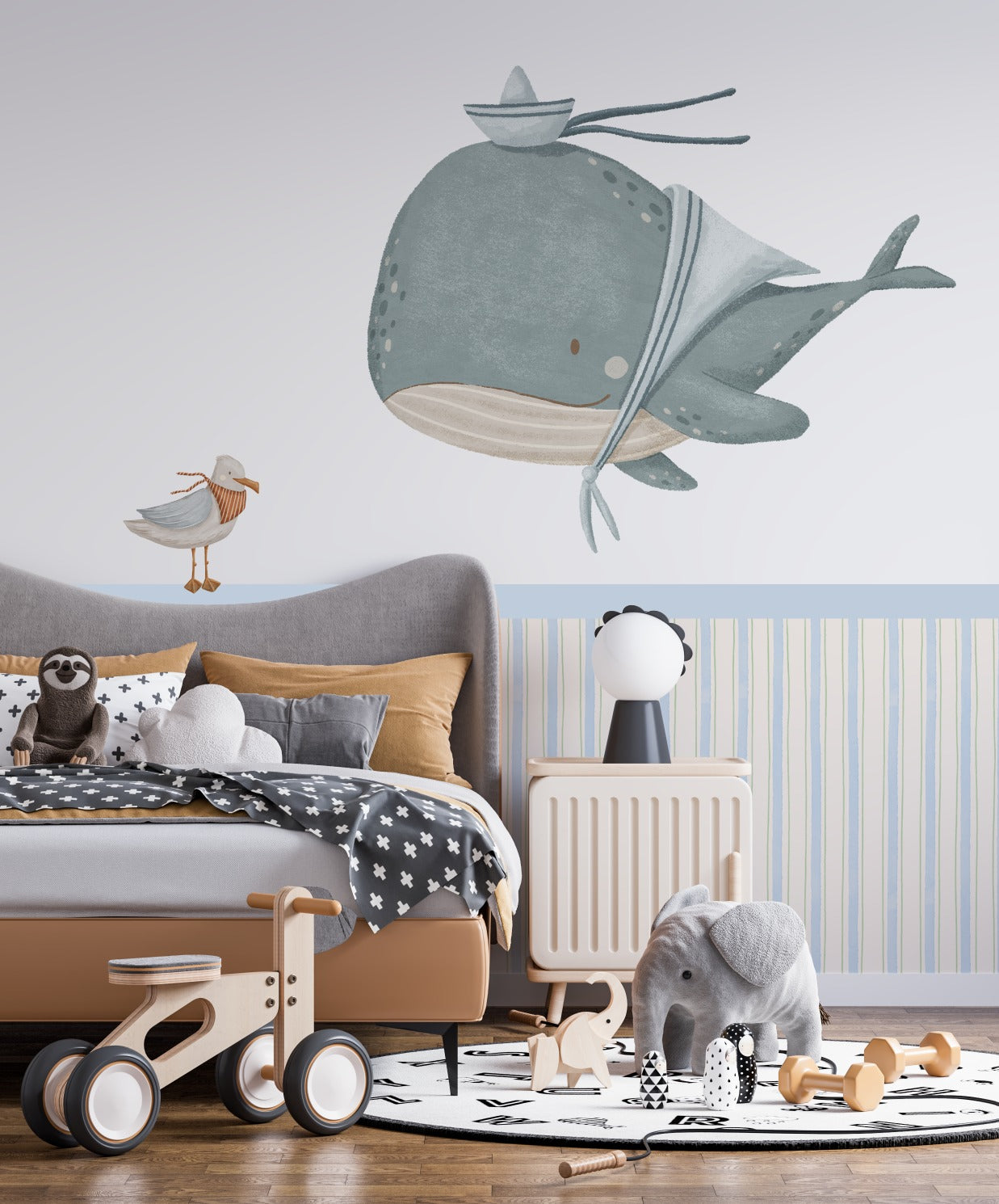 Whale and seagull half-wall decal in a styled kids' bedroom with wooden toys and furniture — Tiny Tale Prints